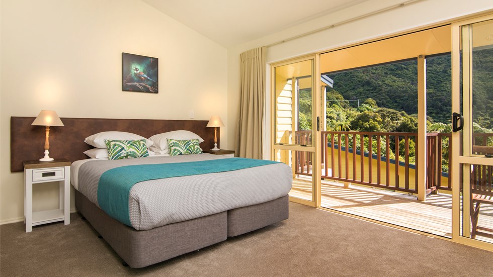 Fern Studios include a spacious bedroom with a private balcony for relaxing and enjoying scenic Endeavour Inlet views at Punga Cove in the Marlborough Sounds of New Zealand