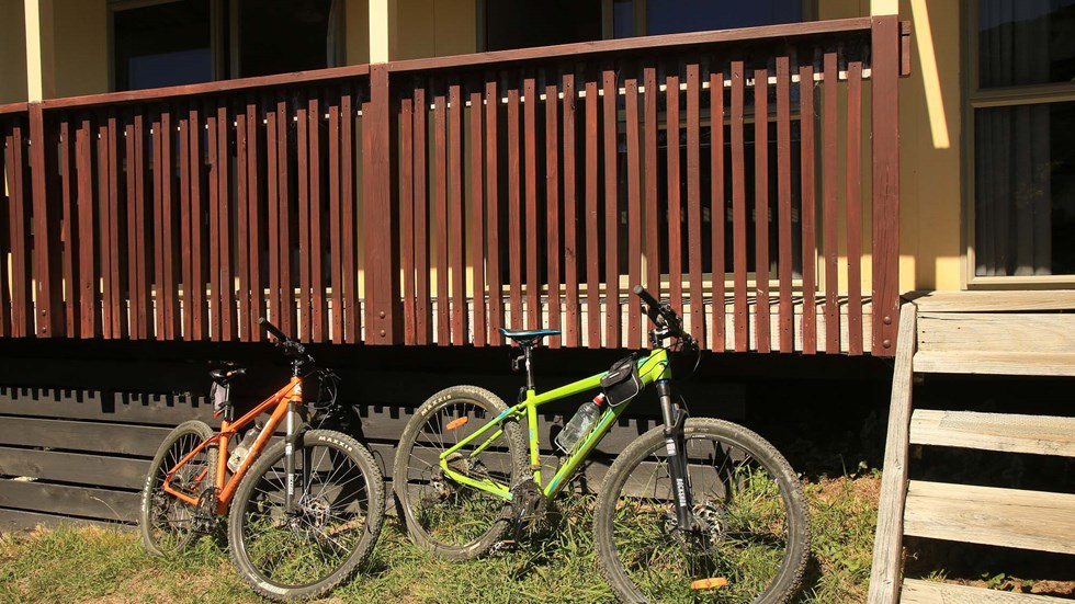Queen Charlotte Track bikes rest beside the Basecamp accommodation balcony at Punga Cove in the Marlborough Sounds in New Zealand's top of the South Island