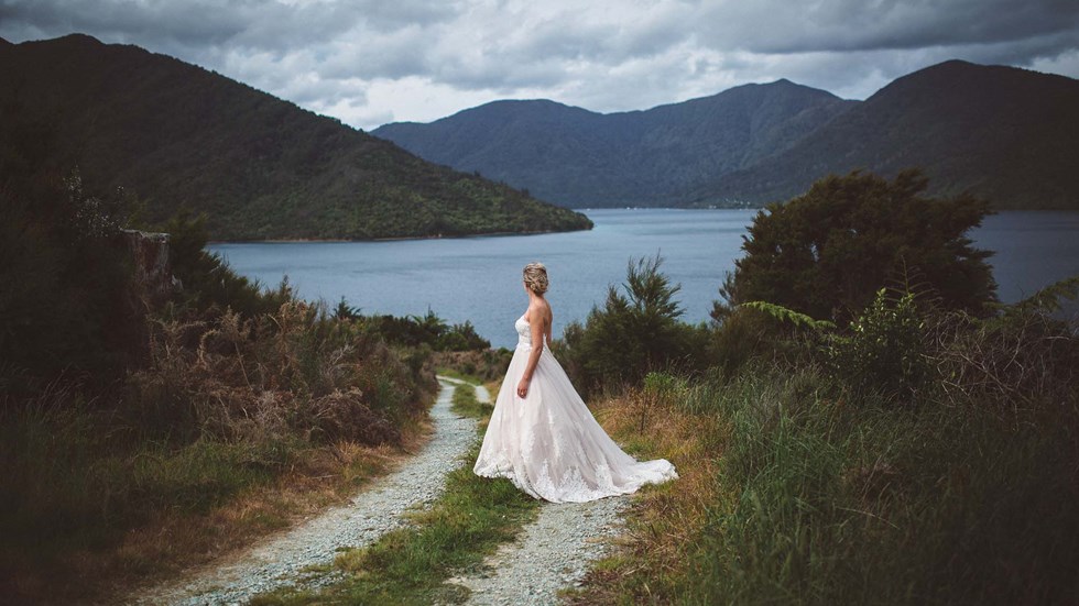 Endeavour Inlet provides scenic views and a background for this bride to admire at Punga Cove in New Zealand's South Island Marlborough Sounds