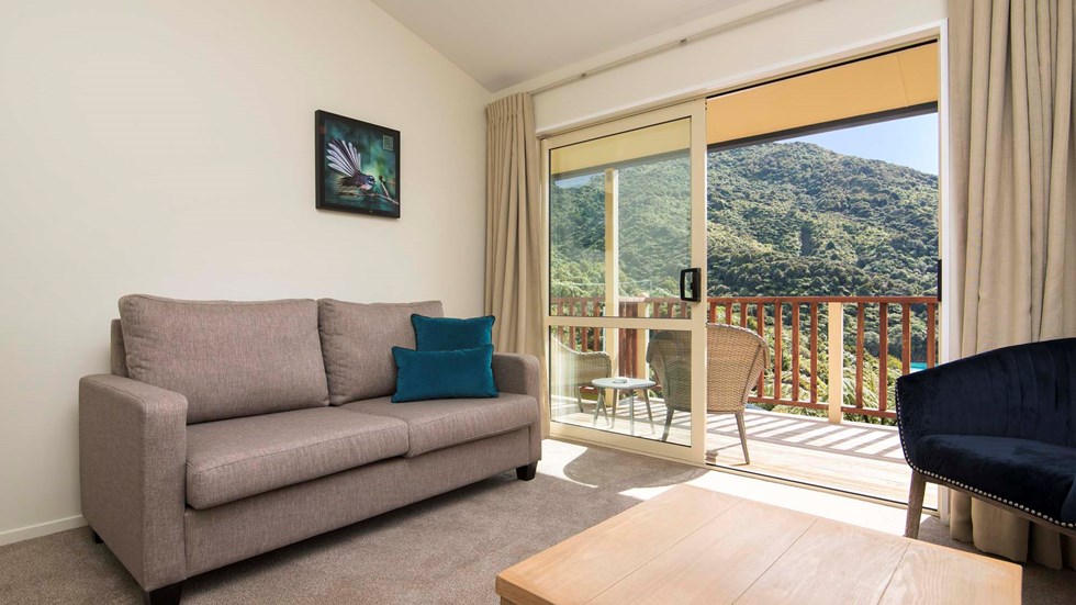 Frond Suite accommodation rooms have a spacious lounge area with sofas and seating and private balcony at Punga Cove in the Marlborough Sounds in New Zealand's top of the South Island