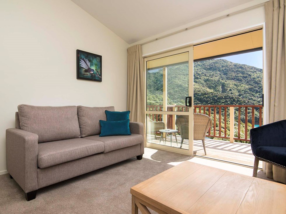 Frond Suite accommodation rooms have a spacious lounge area with sofas and seating and private balcony at Punga Cove in the Marlborough Sounds in New Zealand's top of the South Island