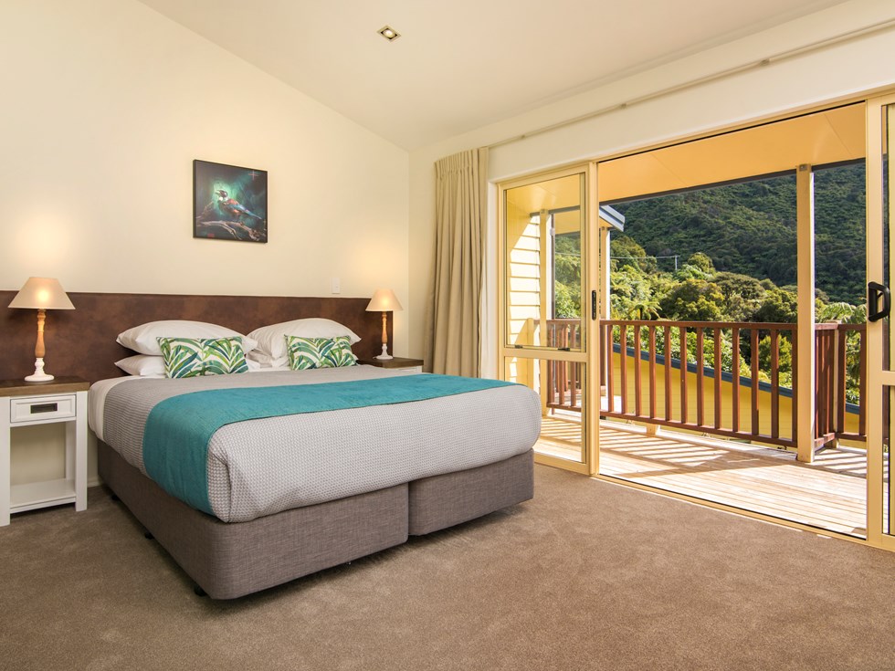 Fern Studios include a spacious bedroom with a private balcony for relaxing and enjoying scenic Endeavour Inlet views at Punga Cove in the Marlborough Sounds of New Zealand