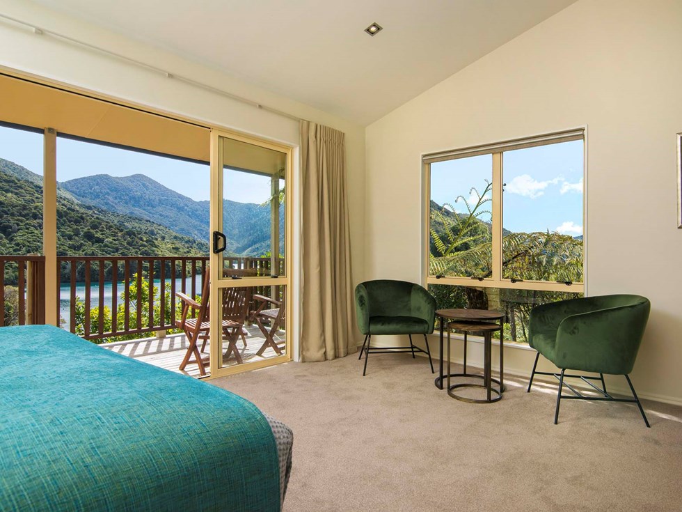 Fern Studios include a spacious bedroom and seating area with a private balcony for relaxing and enjoying scenic Endeavour Inlet views at Punga Cove in the Marlborough Sounds of New Zealand