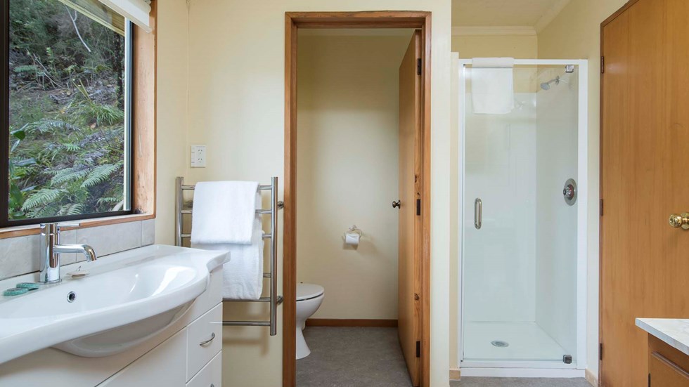 The Mamaku Apartment accommodation room bathrooms feature a shower and some a bath at Punga Cove in the Marlborough Sounds in New Zealand's top of the South Island