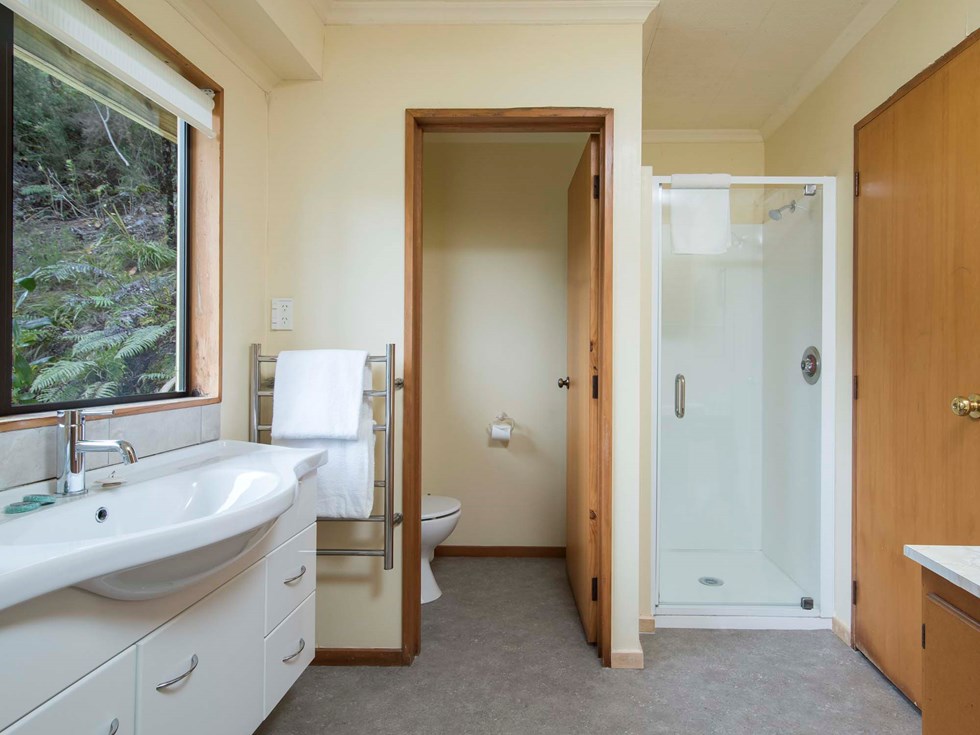 The Mamaku Apartment accommodation room bathrooms feature a shower and some a bath at Punga Cove in the Marlborough Sounds in New Zealand's top of the South Island