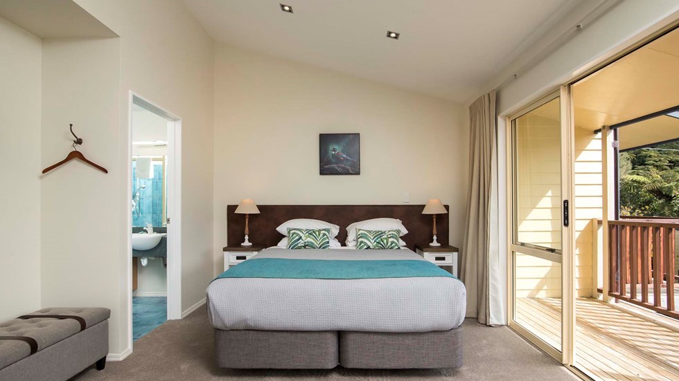 Fern Studios include a spacious bedroom area with a King bed and private balcony for relaxing and enjoying scenic Endeavour Inlet views at Punga Cove in the Marlborough Sounds of New Zealand